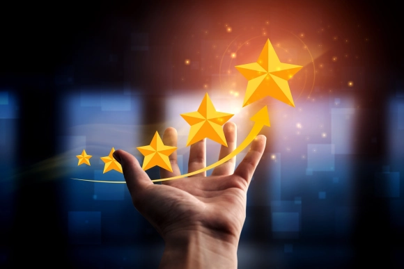 Hand reaching towards golden stars symbolizing growth quality and customer satisfaction with Buildwell ceiling products