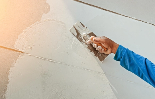 worker applying Buildwell jointing compound on gypsum board – Buildwell