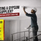 Construction professional applying gypsum plaster on ceiling, representing quality checks used to choose the best gypsum plaster supplier in India