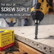 Close-up of a power drill fastening drywall screws into a gypsum board with a box of drywall screws nearby, highlighting the Best Drywall Screw Supplier in India