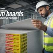 Construction professional inspecting Gypsum Boards used for commercial ceiling installation