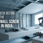 Worker holding a drywall screw near gypsum boards and tools representing the Best Drywall Screw Supplier in India