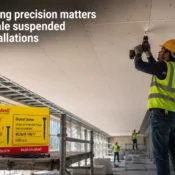 Worker installing suspended ceiling panels using premium drywall screws from a trusted drywall screw manufacturer in India for precise fastening and secure gypsum board alignment
