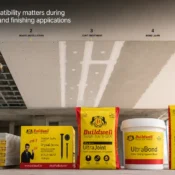 Worker installing gypsum ceiling system with compatible ceiling and gypsum plaster products in India including gypsum boards, drywall screws, joint compound, gypsum bond, and plaster finish