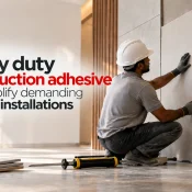 Heavy Duty Construction Adhesive used by a worker to install large decorative wall panels securely in a modern interior space