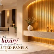 Luxurious modern foyer featuring a Gold Fluted Panel accent wall, elegant marble console, warm LED lighting, brass diyas and marigold decorations for Diwali.