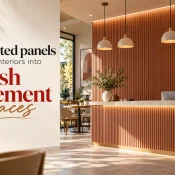 PVC Fluted Panel installed on a modern café reception wall and counter, featuring vertical wood-textured grooves, pendant lights, and warm integrated lighting