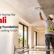 Gypsum Bond being applied with a roller to an RCC ceiling by a construction worker wearing a safety helmet and reflective harness, preparing the surface for plastering